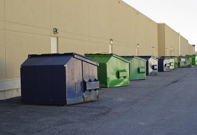 a row of blue construction dumpsters on a job site in Ballwin